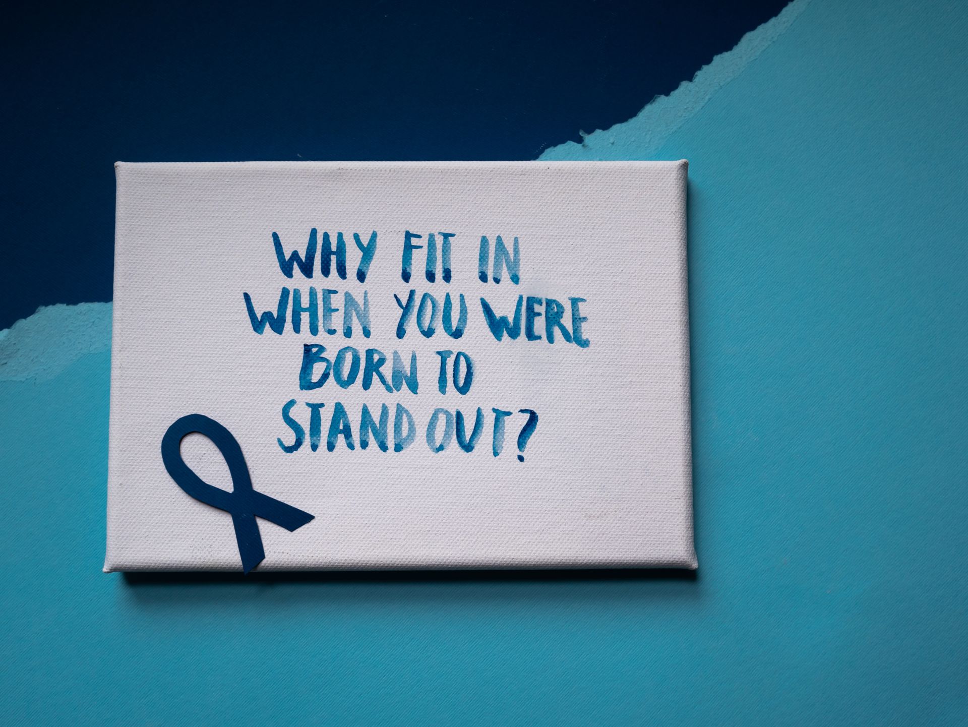 A Motivational Slogan on White Poster with Blue Ribbon