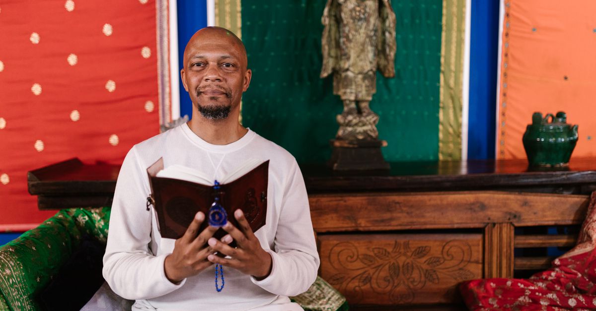 Pastor Prince D smiling, holding a book about holistic health