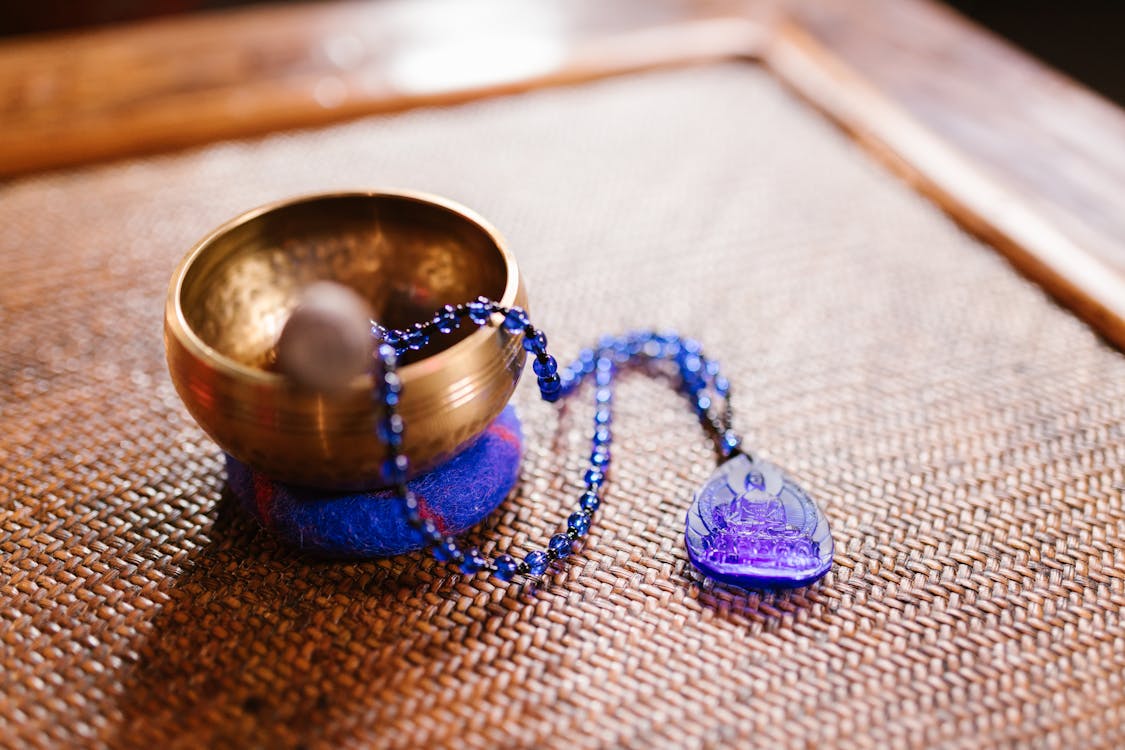 Free Prayer Beads on Top of a Singing Bowl Stock Photo