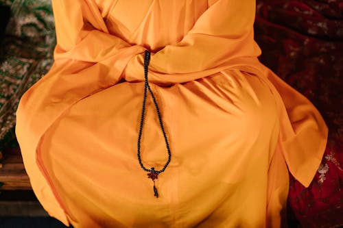A Buddhist Praying with Prayer Beads