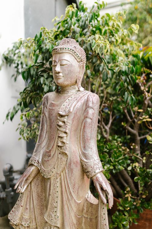 Free A peaceful Buddha statue surrounded by greenery, exuding tranquility. Stock Photo