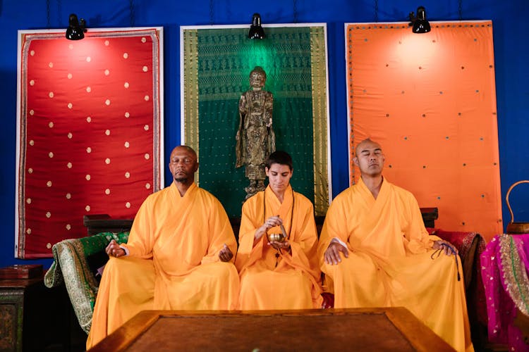 Buddhist Monks Meditating In Prayers