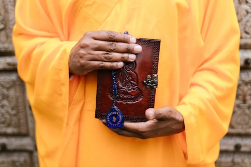 A Person Holding a Buddhist Book