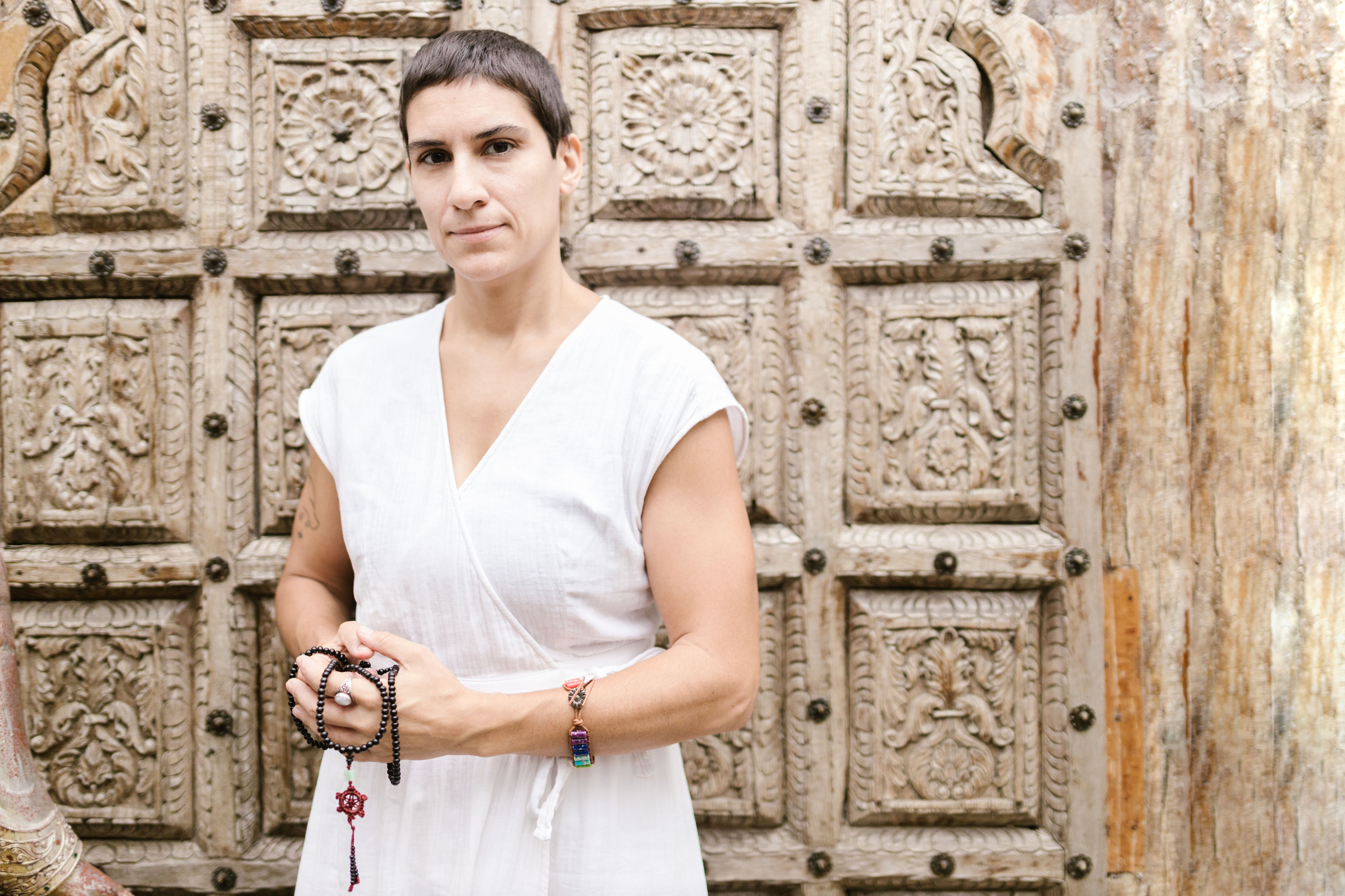 A Woman in White Top Holding Black Prayer Beads · Free Stock Photo