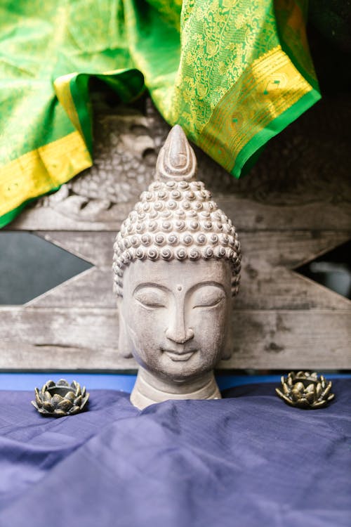 White Buddha Head Bust on Blue Textile
