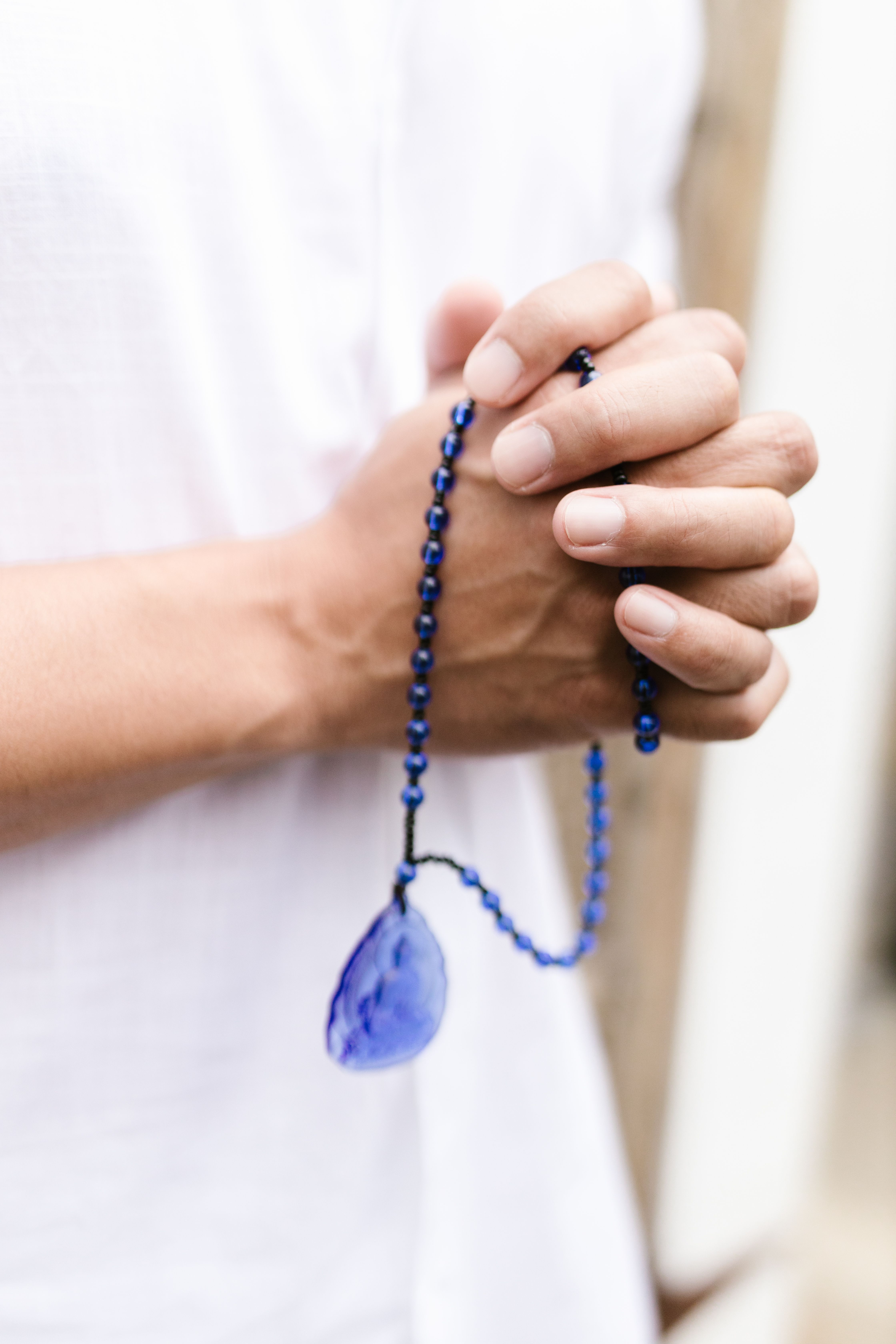 A Person Praying with Prayer Beads on Hand · Free Stock Photo