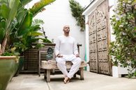 Man in White Long Sleeve Shirt Sitting on Brown Wooden Bench