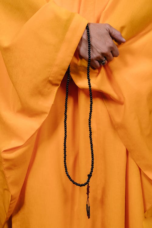 A Buddhist Holding a Black Prayer Beads