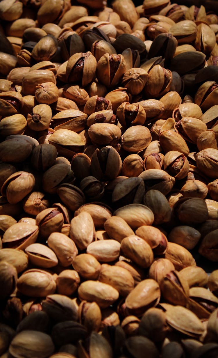 A Stack Of Pistachio Nuts With Shells