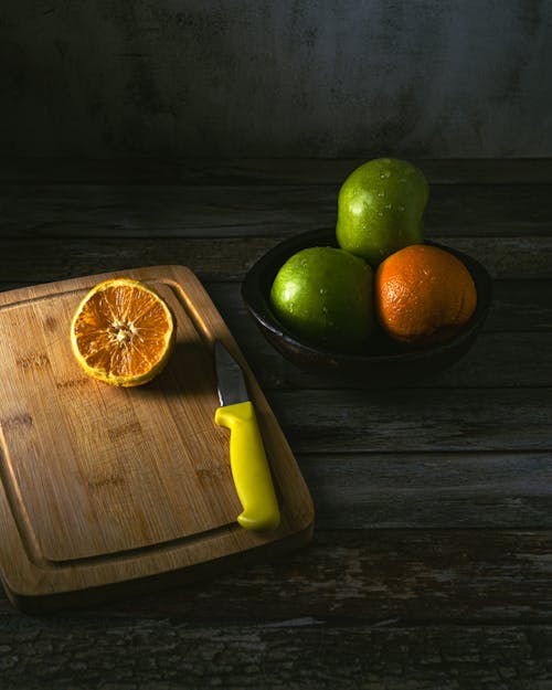 Citrus Fruit over a Wooden Chopping Board