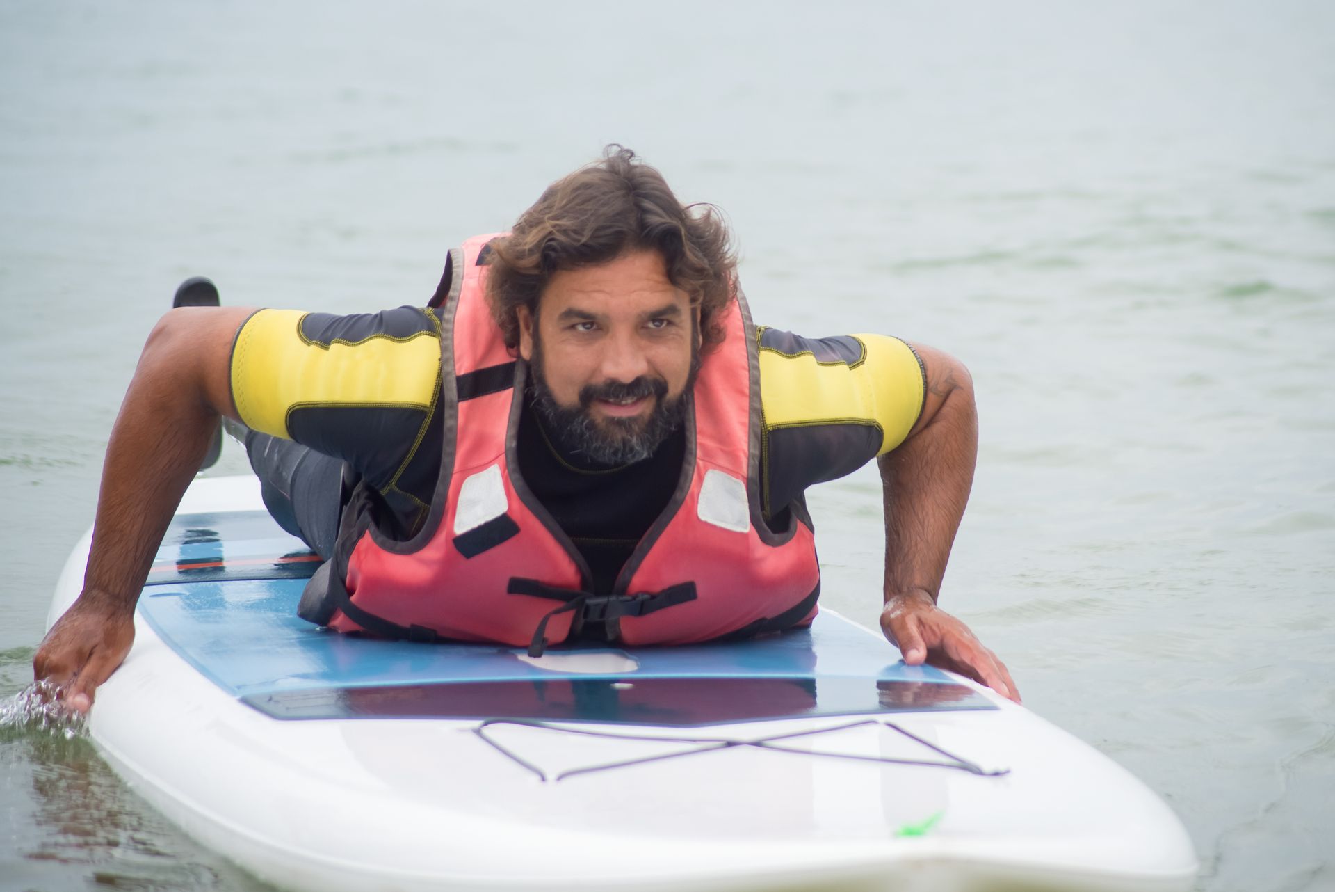 A Man Lying on His Sup Board