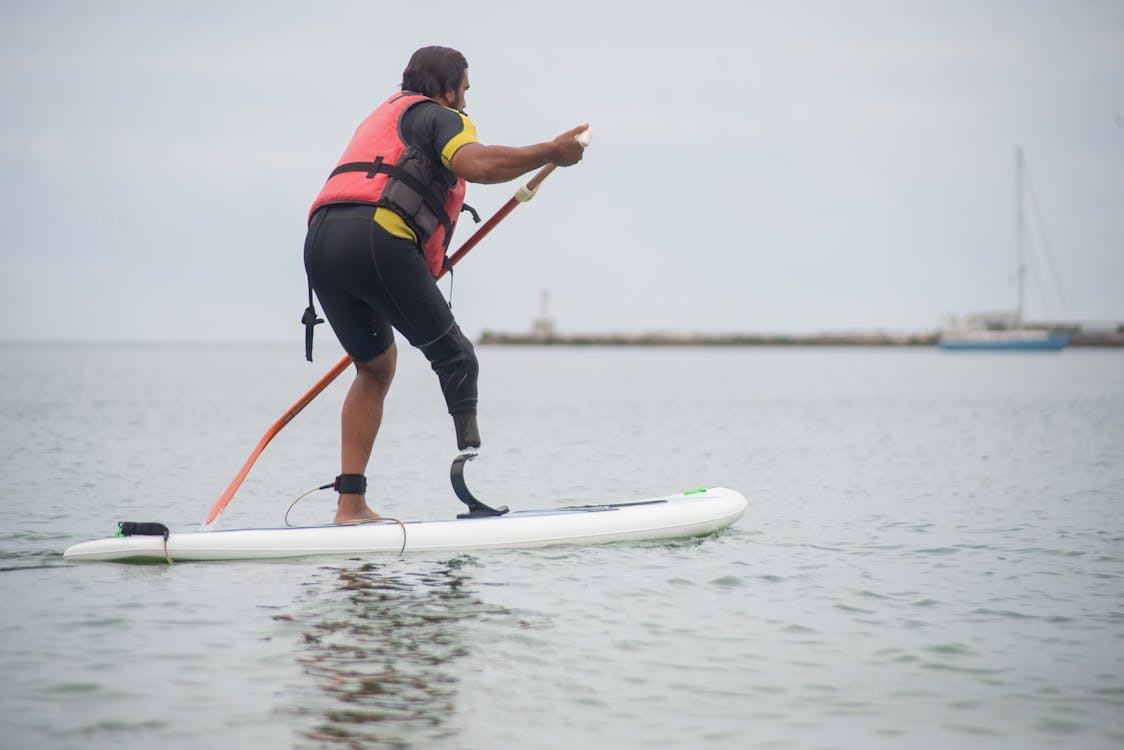 A Man Paddle Boarding in the Sea