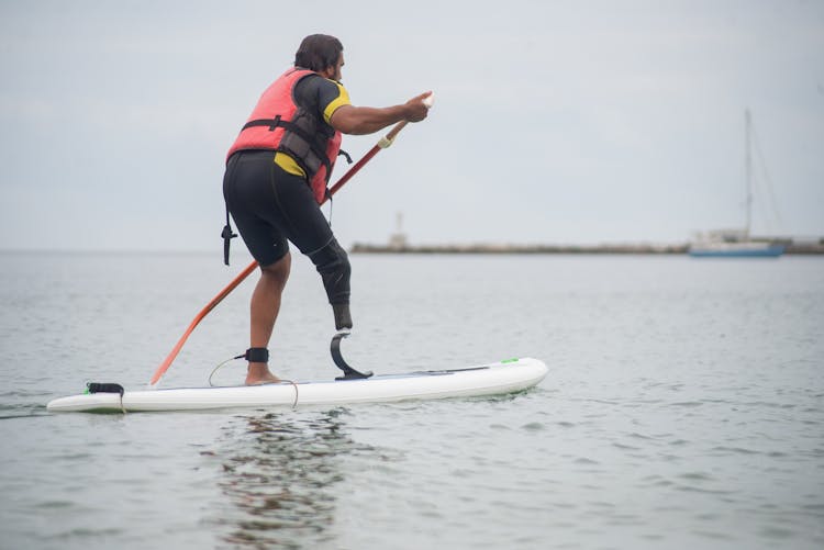 A Man Paddle Boarding In The Sea