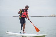 A Man with Prosthetics Paddle Boarding