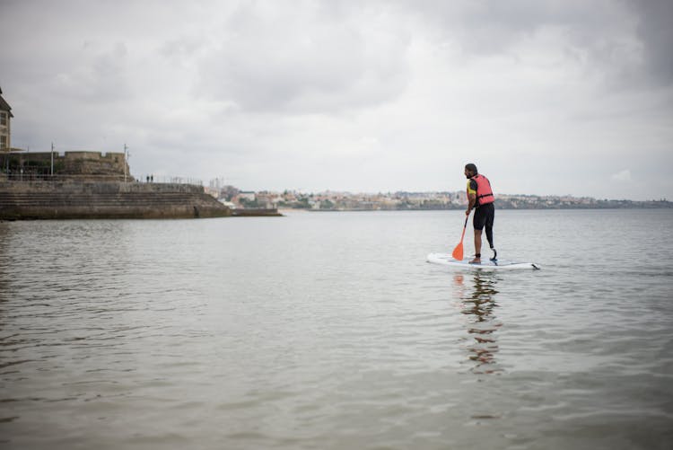 Man Standing On A Standup Paddleboard