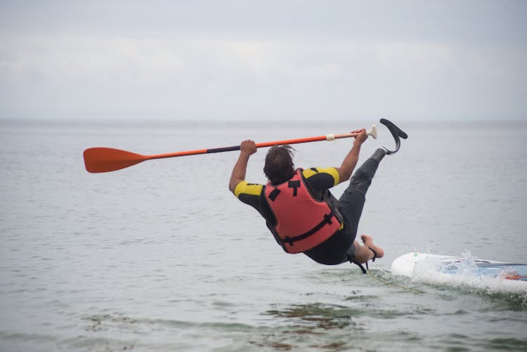 Man Falling From A Standup Paddleboard