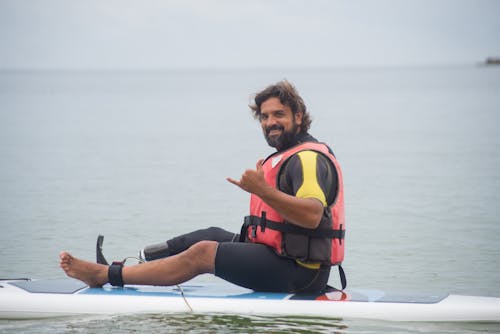 A Man Sitting on a Floating Paddleboard