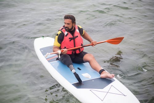 A Man Practicing Standup Paddleboarding