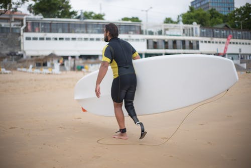 A Man Holding White Surfboard