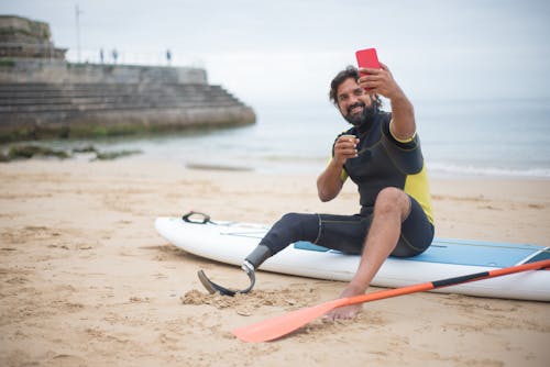 A Man Taking a Selfie on the Beach