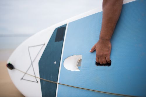 Free A close-up view of a hand holding a surfboard, capturing the beach vibe in Portugal. Stock Photo