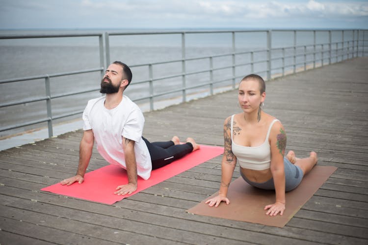 A Couple Doing Yoga Exercise