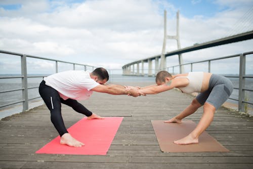 A Couple Doing Yoga Exercise