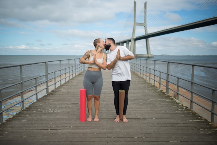 A Couple Kissing In The Boardwalk