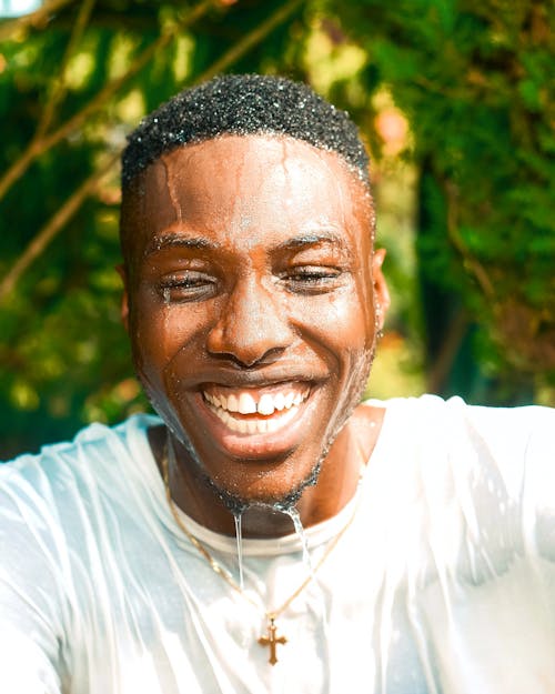 Free Portrait of a Man Smiling with Water Dripping from His Face Stock Photo