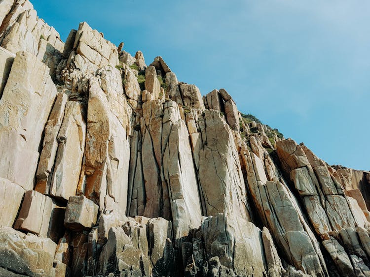 Low Angle Shot Of A Cliff Wall Under The Sky