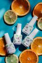 A Few Bottles of Mio Nail Polish Surrounded with Slices of Citrus Fruits
