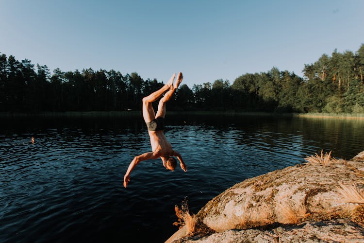 A Man Jumping In The Lake