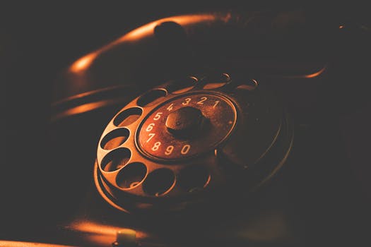 Detailed view of a retro rotary dial telephone with a vintage feel.