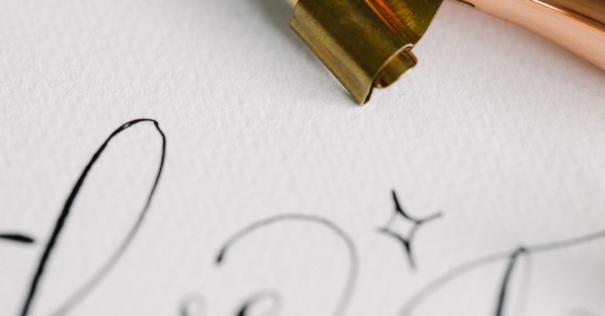 Close-up of an Ink Pen and Calligraphic Writing · Free Stock Photo