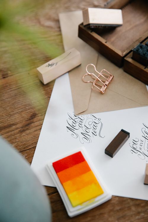 Free Flat lay of calligraphy tools and stationery on a wooden surface, featuring vibrant ink pads and envelopes. Stock Photo