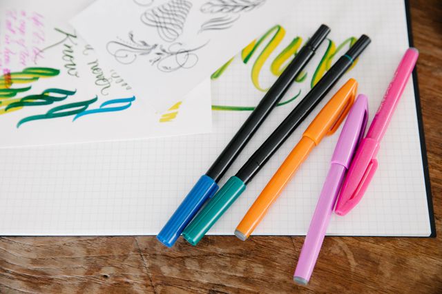 Brush pens on a lettering practice sheet — Katya Wolf on Pexels