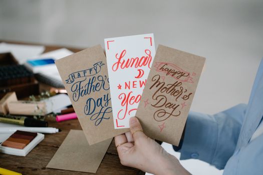 Close-up of handcrafted greeting cards for Father's Day, Mother's Day, and Lunar New Year.