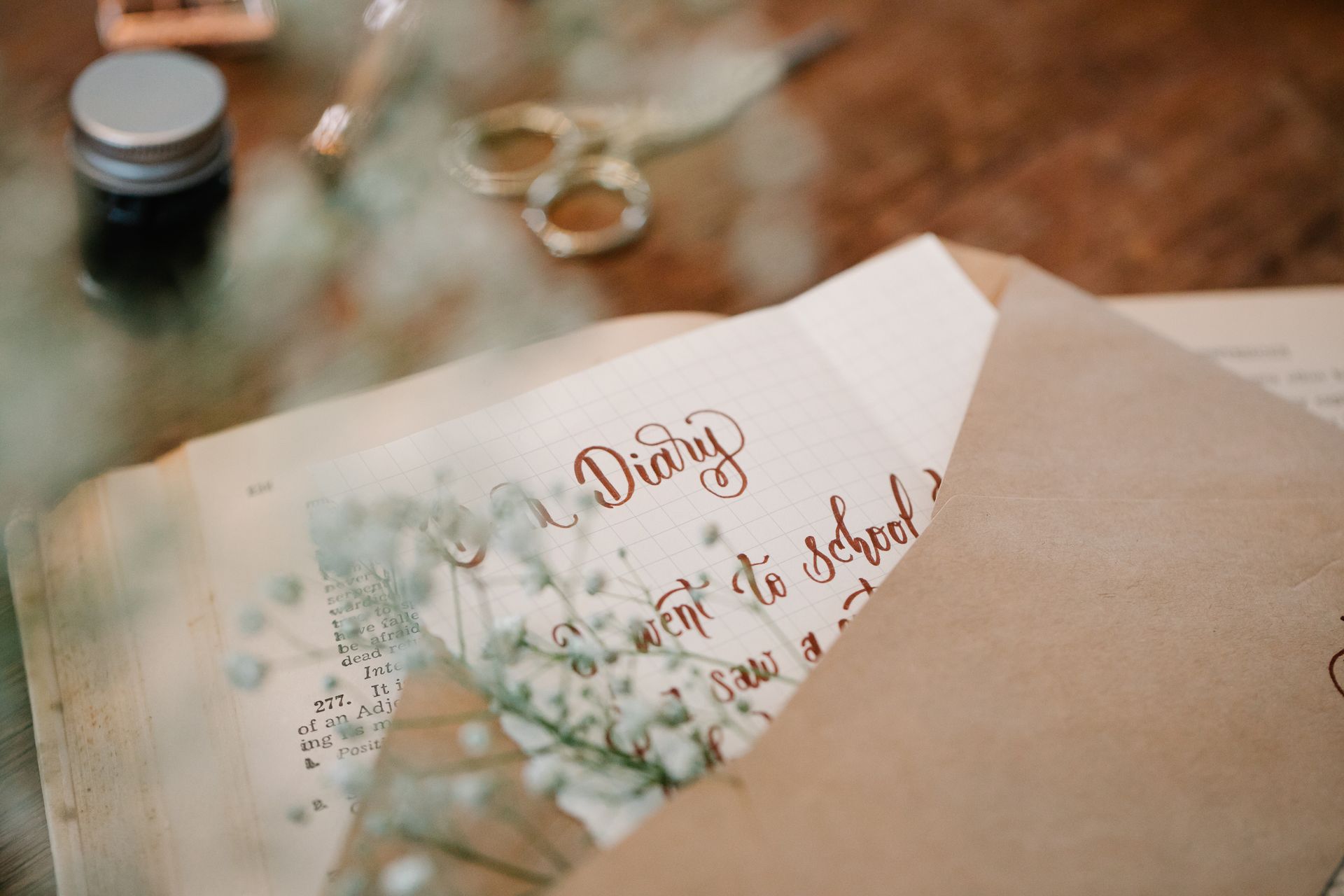 A Diary in a Brown Envelope with a Stem of Flowers