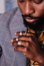 A Man Touching the Lapel of his Gray and White Pinstripe Jacket