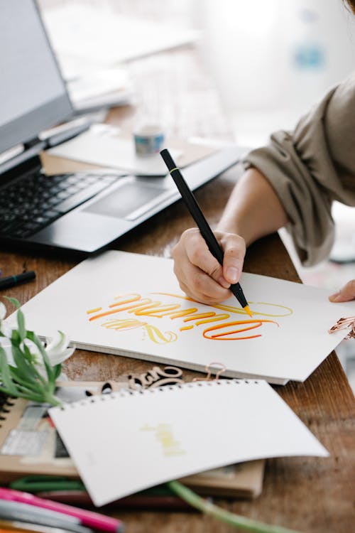 Person Writing on a Sketchpad