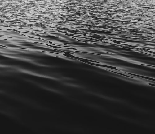 Free Calm ocean water surface in black and white showing gentle ripples. Stock Photo