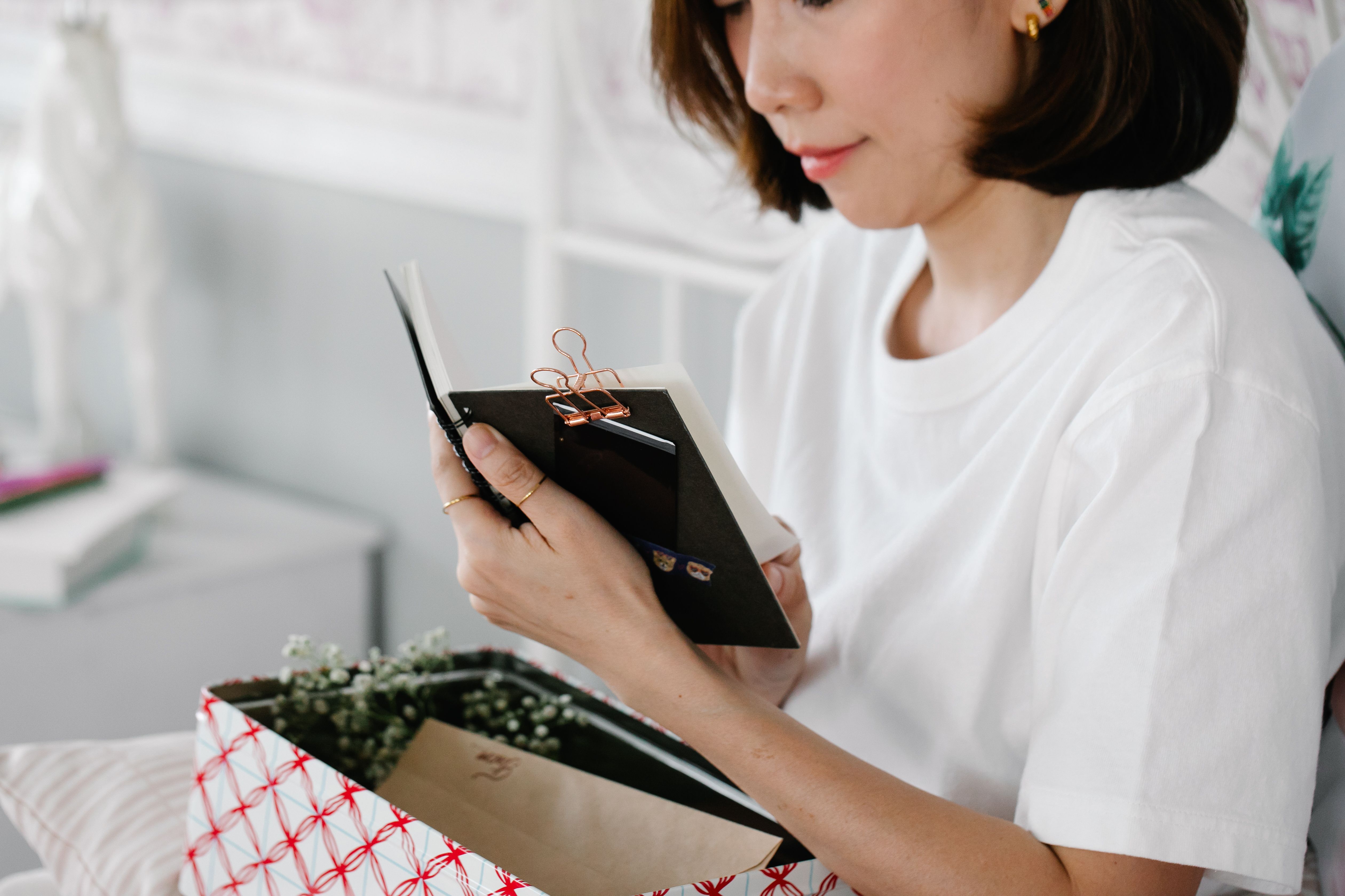 Woman in White Shirt Holding a Notepad · Free Stock Photo