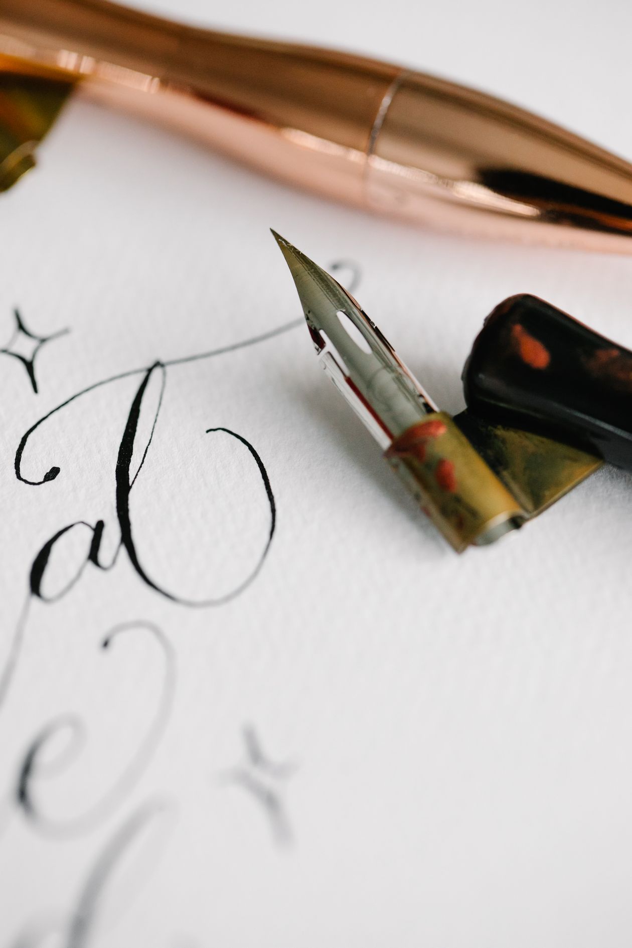 A fountain pen resting on a leather-bound notebook — professional writing setup