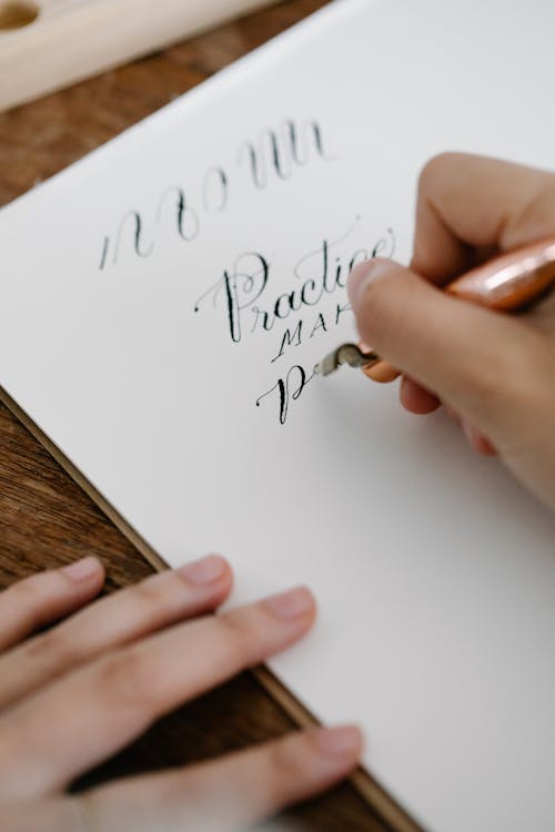 Free Close-Up Shot of Person Writing on Paper Stock Photo