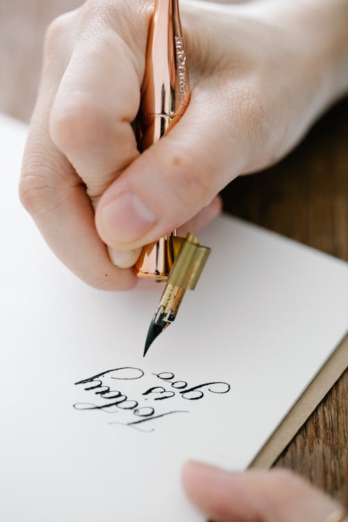 Close-Up Shot of Person Writing on Paper