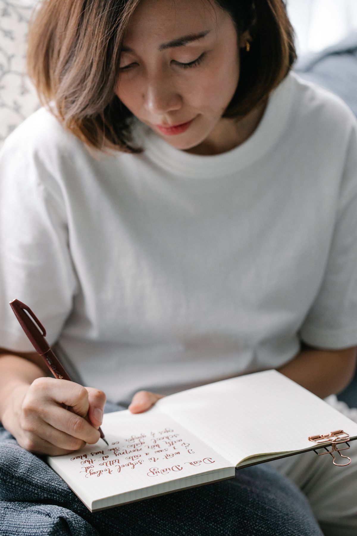 Woman writing in her diary at a table