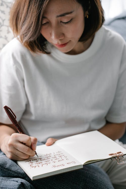 Free Woman Writing Her Diary Stock Photo