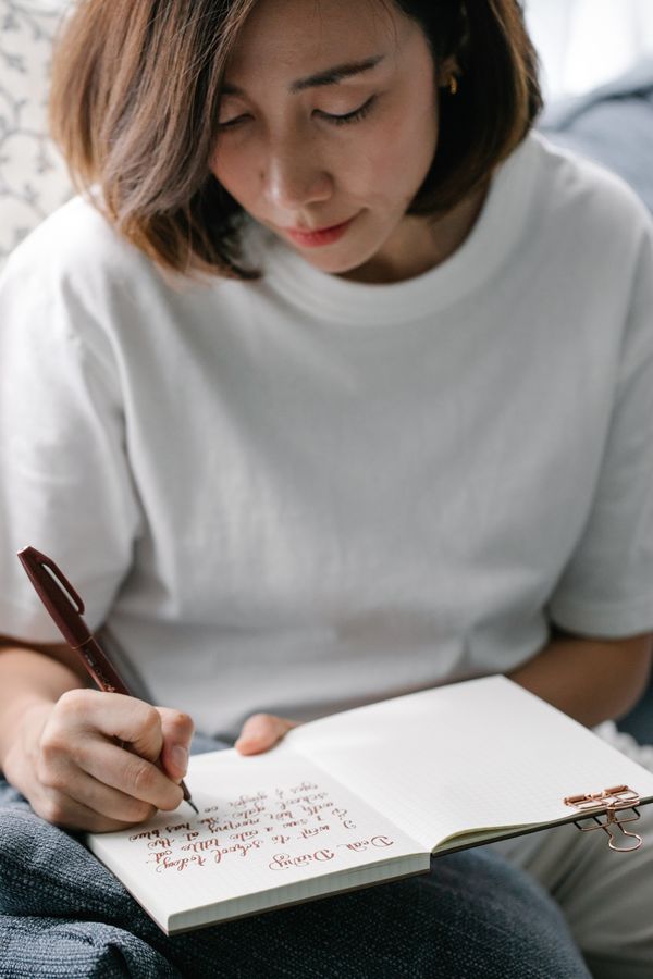 A woman writing quietly in a journal