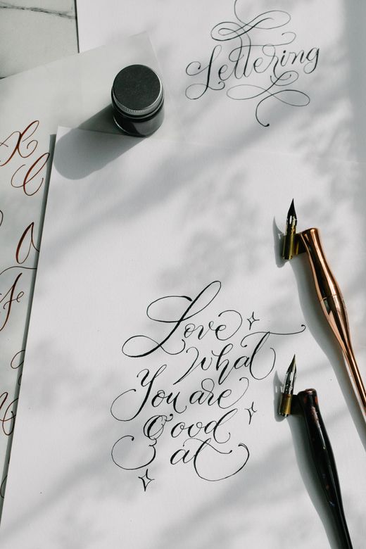 Pointed-pen calligraphy practice sheet with fountain pens — photo by Katya Wolf on Pexels