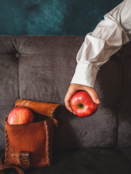 Person Holding a Red Apple